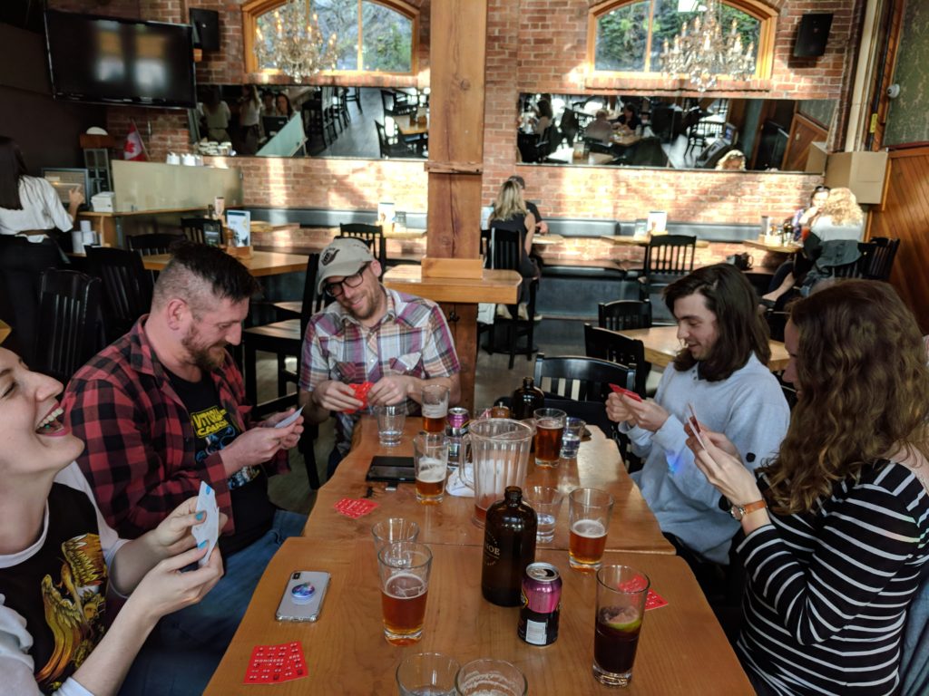 The AE team playing cards and drinking beers at Canoe Brewpub.
