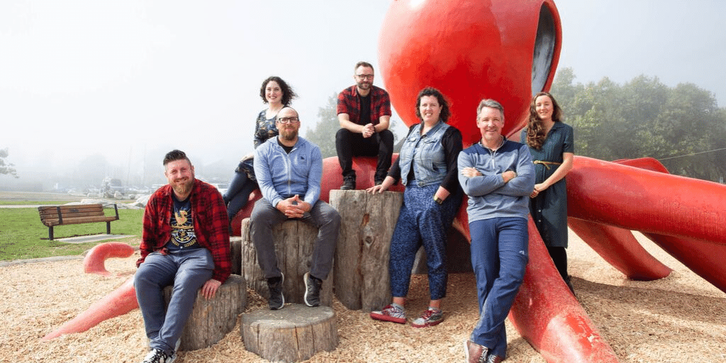 the ae team in front of a red octopus sculpture