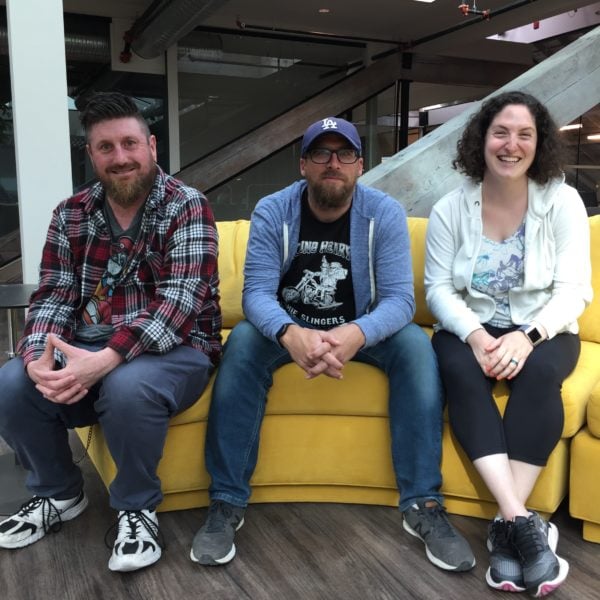 A picture of the AE Dev team on a yellow couch.